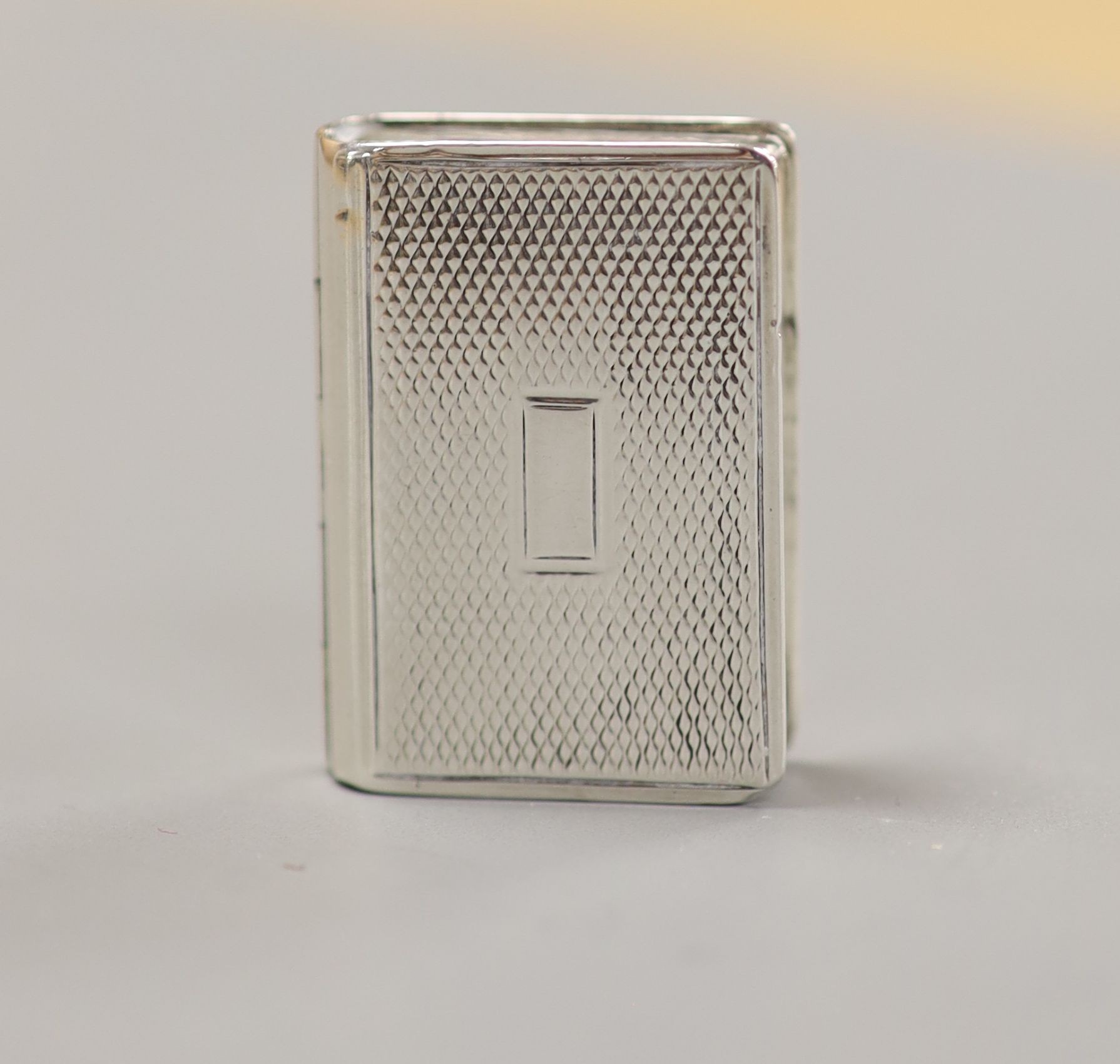 A William IV engraved silver vinaigrette, modelled as a book, Joseph Bettridge, Birmingham,1830, 31mm.